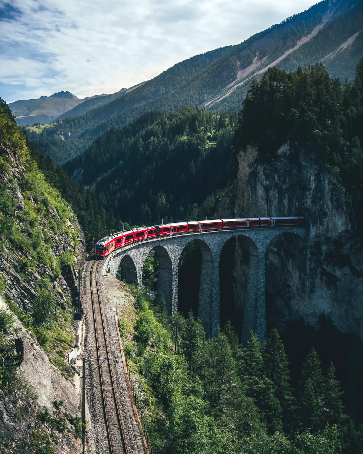 Bernina Express train crossing the Landwasser Viaduct on the Albula line near Filisur — UNESCO World Heritage